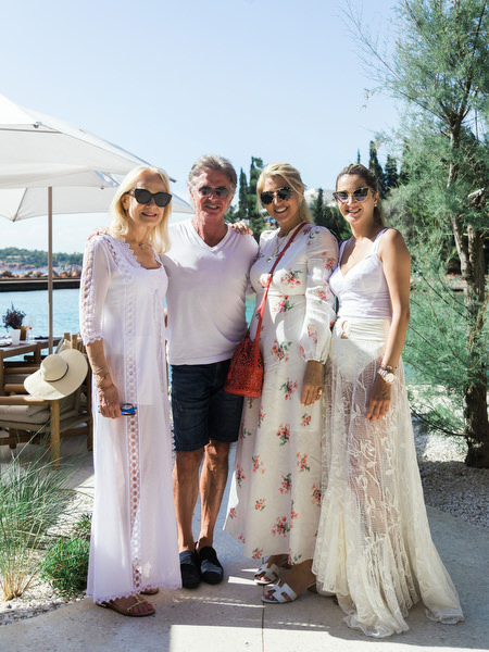 Guests posing together at Four Seasons Astir Palace wedding weekend event