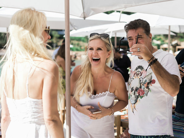 Friends laughing together during relaxed Athens wedding weekend brunch