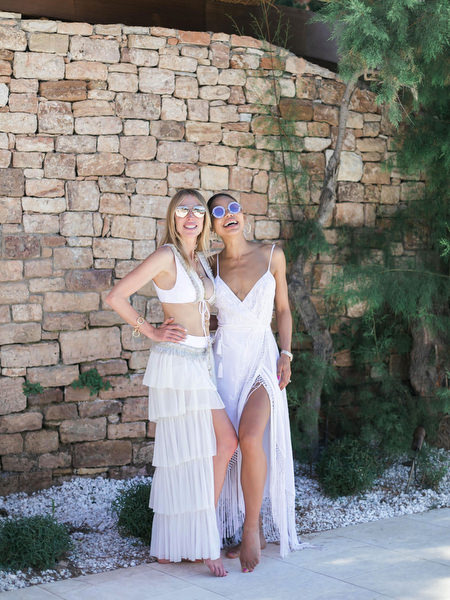 Bride posing playfully against stone wall during wedding weekend brunch