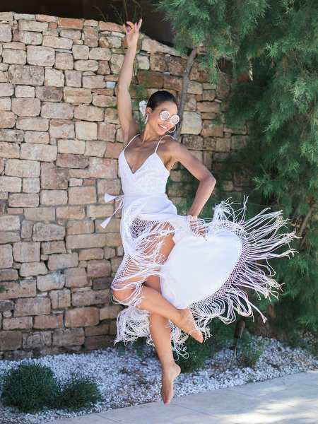 Woman dancing in white dress at Athens post-wedding brunch