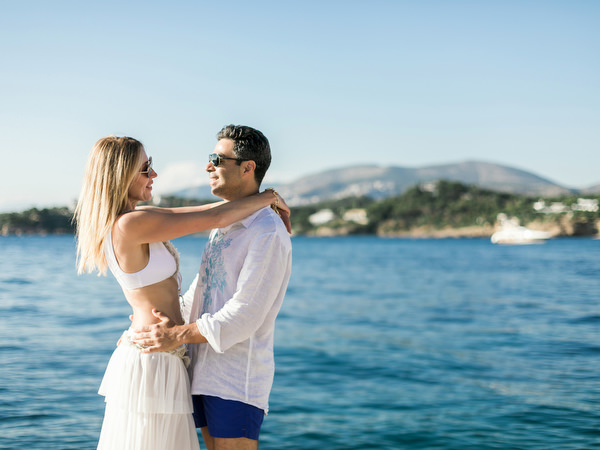 Couple embracing by the sea during Athens destination wedding weekend