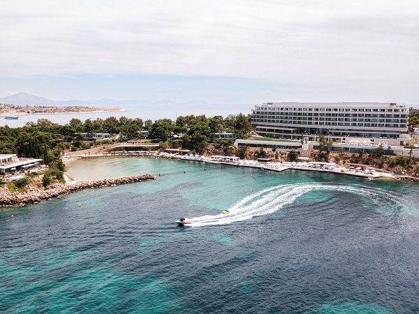 Speedboat cutting through turquoise waters near Four Seasons Astir Palace on the Athens Riviera, setting the scene for a destination Athens wedding