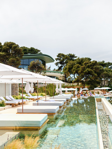 Infinity pool and sunbeds at Four Seasons Astir Palace, a luxury venue for a destination Athens wedding on the Athens Riviera