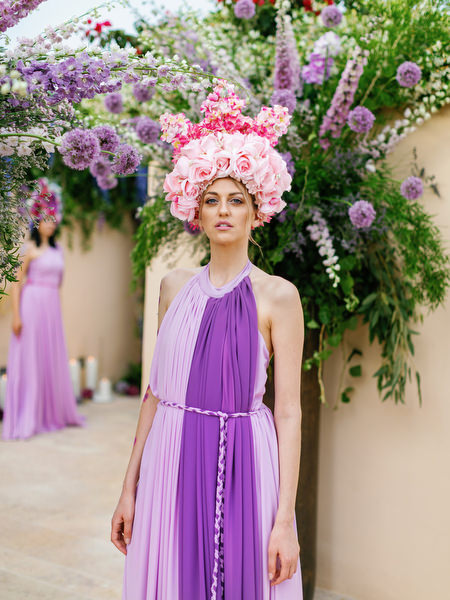 Guest in lilac gown with statement floral headpiece at a luxury Athens wedding at Island Resort Athens Riviera
