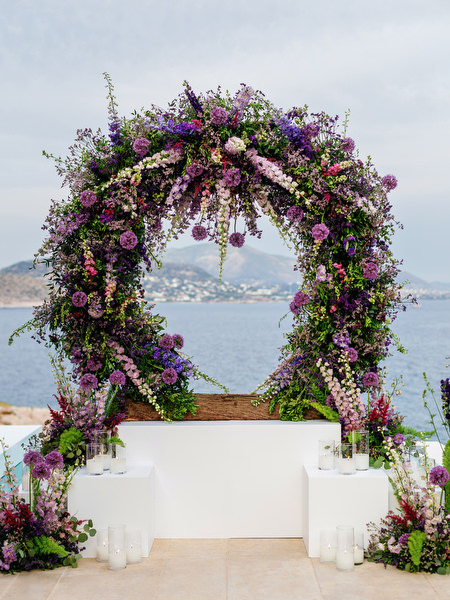Floral ceremony arch overlooking the sea during a luxury Athens wedding at Island Resort Athens Riviera on the Athens Riviera
