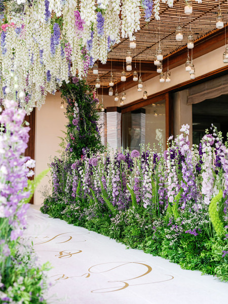 Lavish purple and green floral aisle installation at a couture Athens wedding at Island Resort Athens Riviera