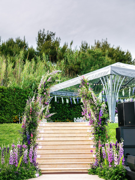 Clear marquee reception entrance decorated with lilac florals for an Athens Riviera wedding at Island Resort Athens Riviera