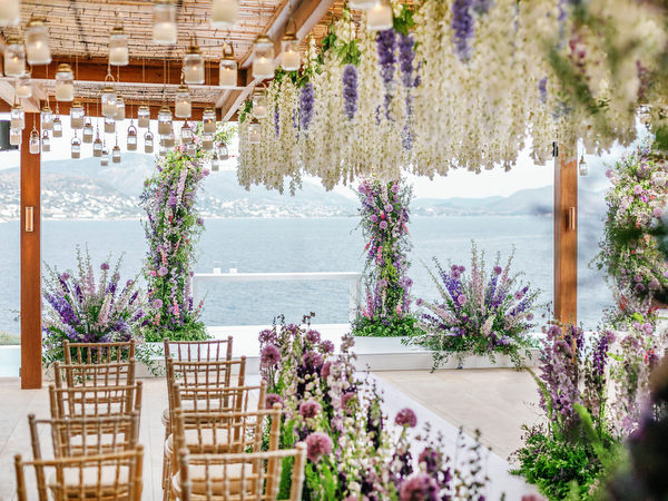 Reception ceremony space with sea views and cascading florals at a couture Athens wedding at Island Resort Athens Riviera