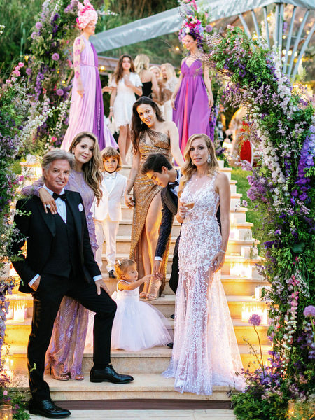 Guests gathered on illuminated steps framed with florals at an Island Resort Athens Riviera Riviera wedding