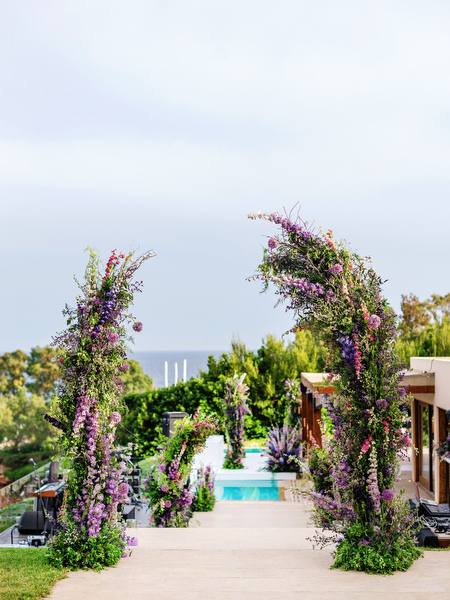 Floral entrance pathway overlooking the sea during a luxury Athens wedding at Island Resort Athens Riviera on the Athens Riviera