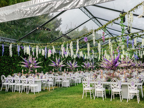 Floral ceiling installation inside a clear tent during an Island Resort Athens Riviera Riviera wedding celebration