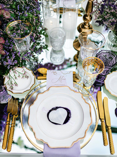 Luxury tablescape with gold-rimmed plates and lilac accents at an Athens wedding reception at Island Art & Taste