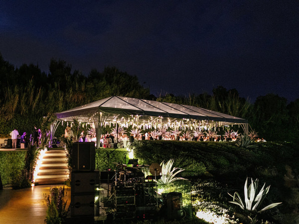Night view of illuminated reception marquee at Island Resort Athens Riviera during a luxury Athens Riviera wedding