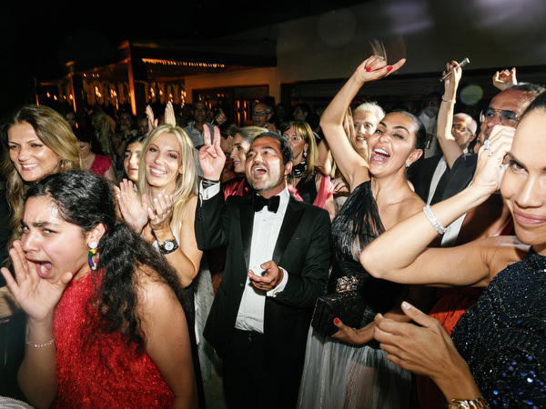 Crowd cheering on the dance floor at a luxury Athens Riviera wedding at Island Art & Taste
