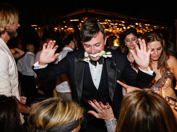 Groom dancing surrounded by guests at a high-energy Athens wedding at Island Resort Athens Riviera