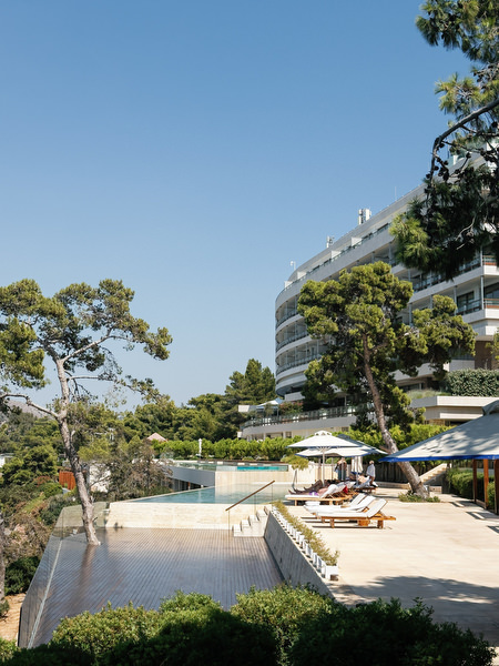 Infinity pool and seaside terraces at Four Seasons Astir Palace Athens overlooking the Aegean Sea