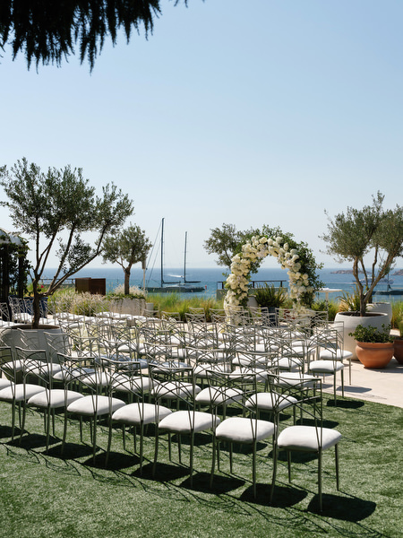 Rows of elegant white chairs arranged for ceremony at Four Seasons Astir Palace Athens wedding