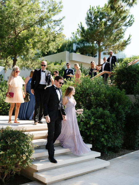 Well-dressed couple in formal attire arriving at Four Seasons Astir Palace Athens wedding