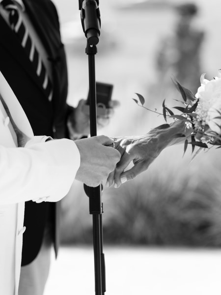 Bride and groom exchanging rings during black-tie wedding ceremony at Four Seasons Athens
