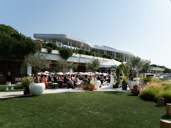 Full view of ceremony lawn and guests at Four Seasons Astir Palace Athens overlooking the sea