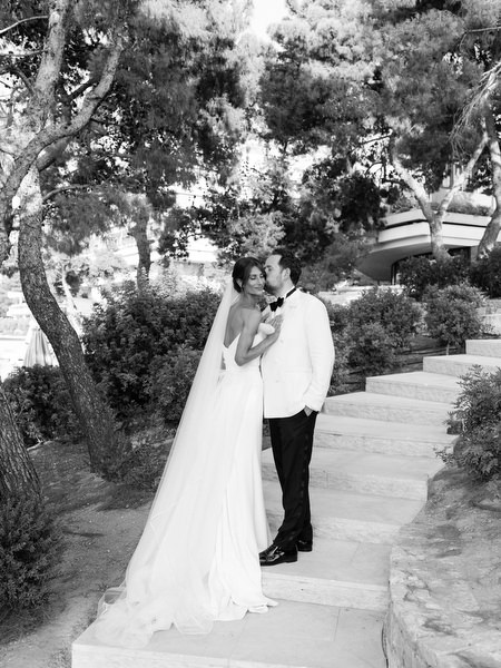 Bride and groom embracing beneath trees during sunset portraits on the Athenian Riviera