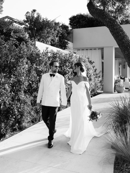 Bride and groom strolling through landscaped gardens at Four Seasons Astir Palace Athens