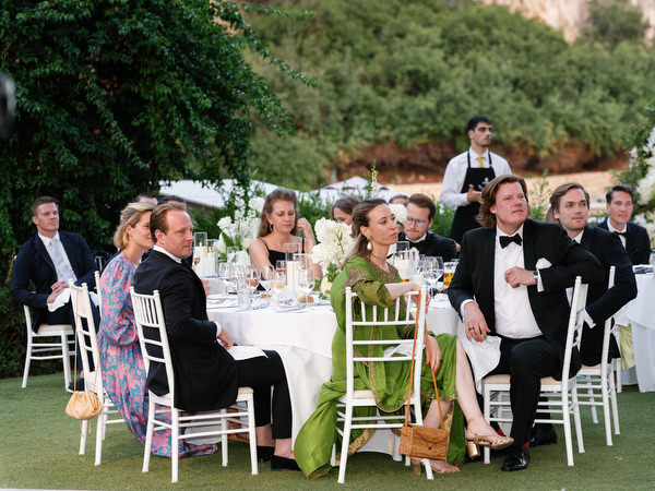 Wedding guests seated attentively during emotional reception speech
