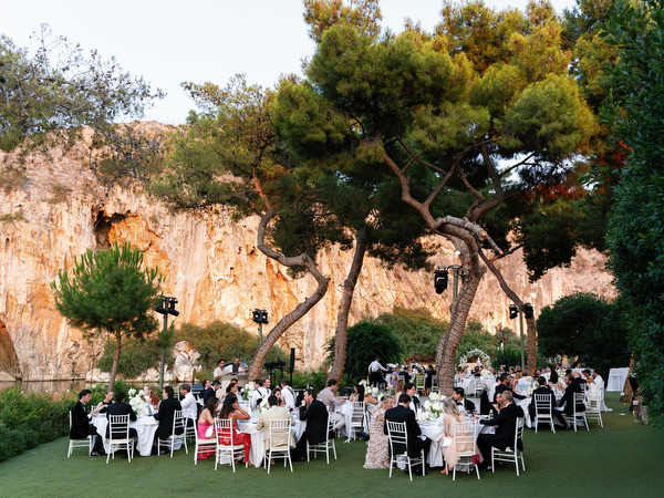 Wide view of wedding guests laughing and celebrating during dinner moment