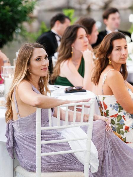 Wedding guests seated attentively during emotional reception speech