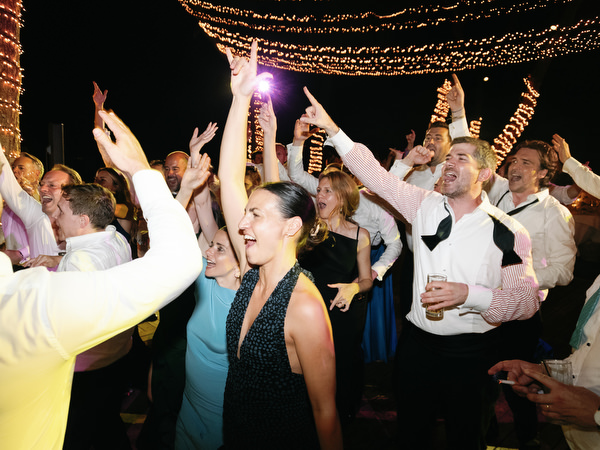 Guests singing and dancing together at black-tie Athens wedding reception