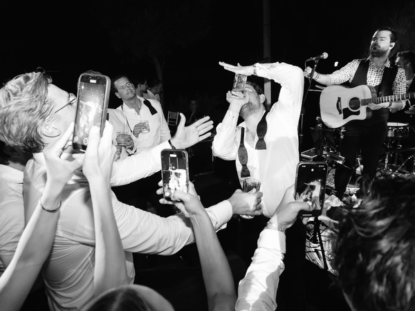 Groom performing among guests during high-energy dance floor moment