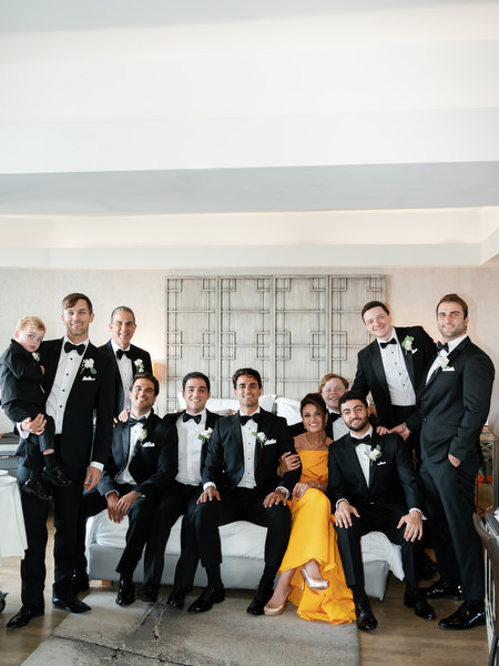 Groom and groomsmen gathered in Divani Apollon Palace and Thalasso hotel suite before Greek Orthodox ceremony in Athens