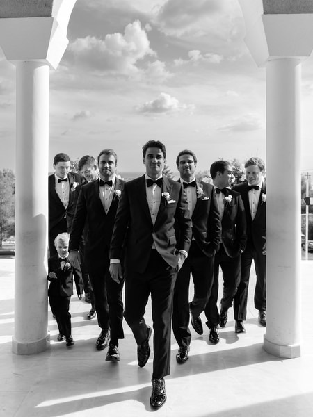 Groom and groomsmen walking confidently into Greek Orthodox ceremony in Athens