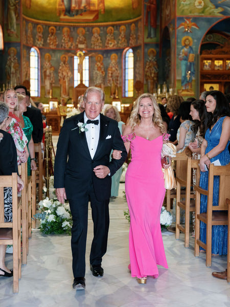 Parents walking down the aisle after Greek Orthodox wedding ceremony in Athens