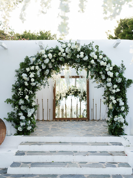 Cascading white floral arch set for luxury wedding at Island Resort Athens Riviera