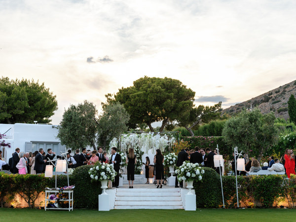 Guests mingling during golden hour cocktail hour at Island Resort Athens Riviera wedding