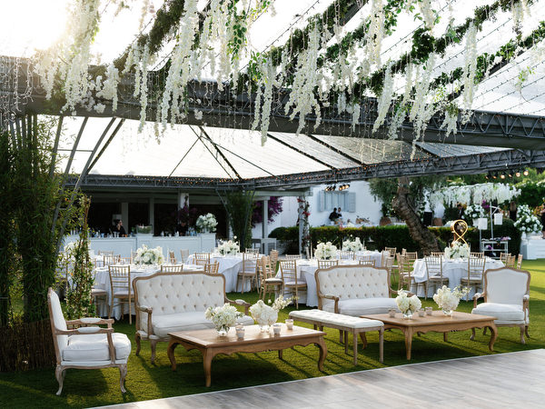 Elegant reception lounge seating beneath hanging white florals at Island Resort Athens Riviera – The Residence
