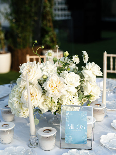 White rose and hydrangea centerpiece with candlelight at luxury Island Resort Athens wedding reception