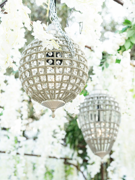 Crystal lantern hanging among cascading white florals at Island Resort Athens Riviera reception