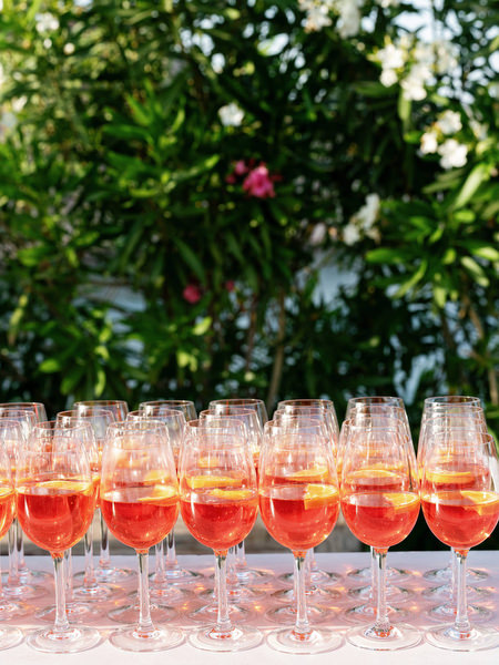 Row of Aperol Spritz cocktails served during golden hour at Island Resort Athens Riviera wedding