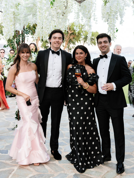 Stylish guests posing with drinks during luxury Athens Riviera wedding reception