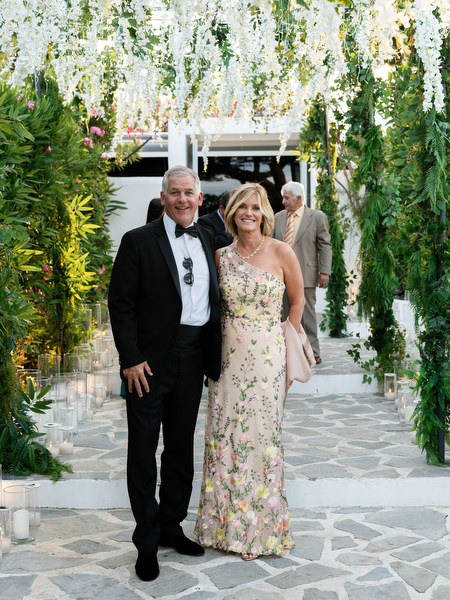 Guests posing beneath cascading greenery at Island Resort Athens Riviera reception