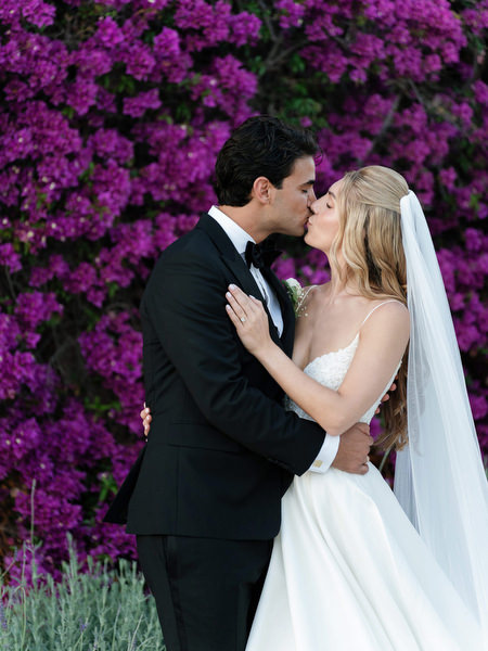 Intimate portrait of bride and groom kissing during golden hour at Island Resort Athens Riviera