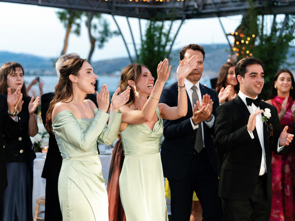 Wedding guests clapping during bride and groom’s first dance at Island Resort Athens Riviera reception