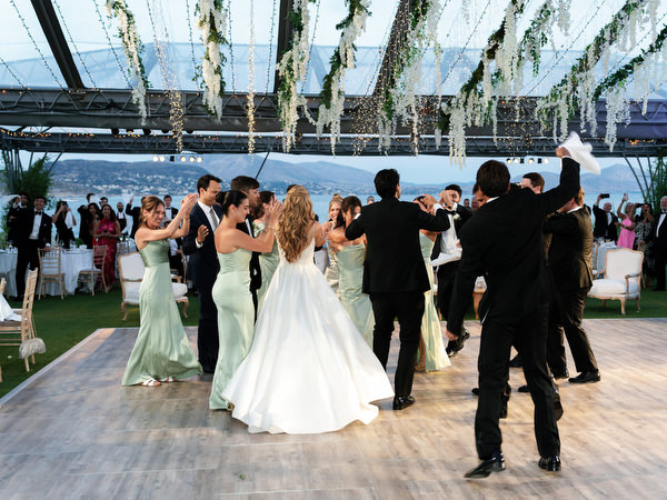 Bride and groom dancing beneath hanging greenery installation at Island Resort Athens Riviera