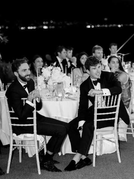 Groomsmen and guests reacting during reception speeches at luxury Athens Riviera wedding