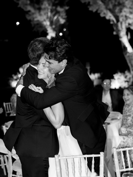 Groom hugging friend during emotional reception speech at Island Resort Athens Riviera