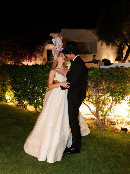 Bride and groom embracing in garden at night during Island Resort Athens Riviera wedding