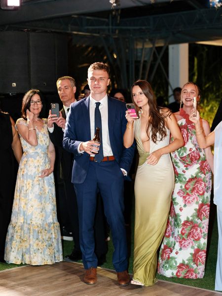 Well-dressed guests watching champagne tower moment at luxury Athens Riviera wedding