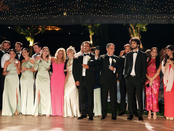 Bridal party and guests gathered together during high-energy reception moment